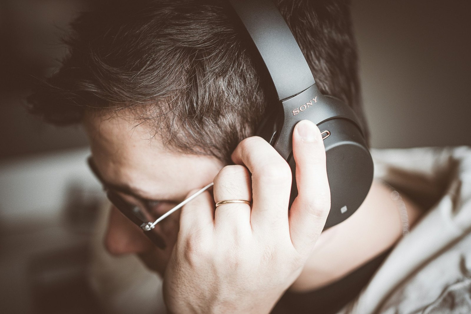 man using black Sony headphones