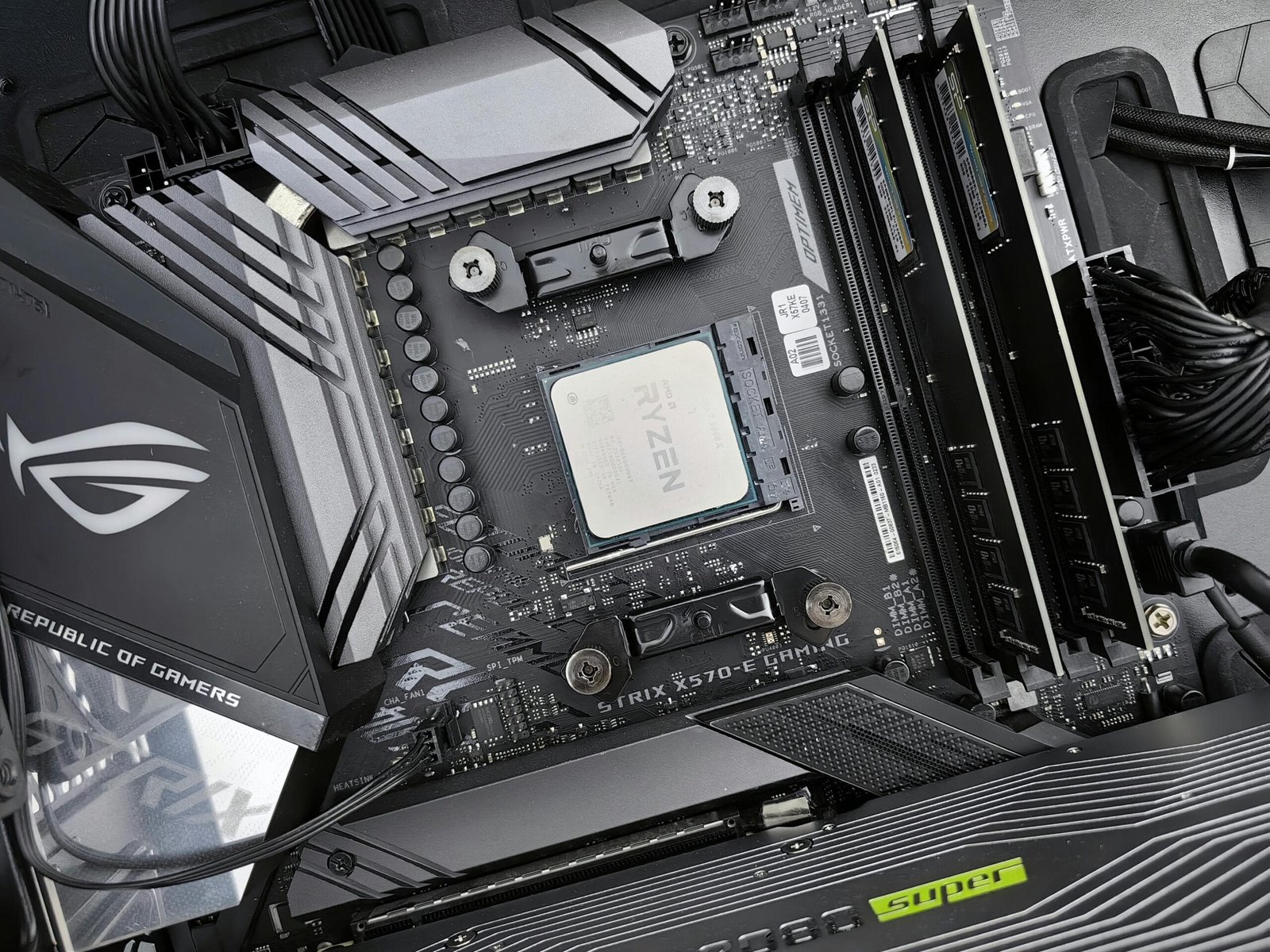 Detailed view of a gaming motherboard, showcasing an AMD processor and components.